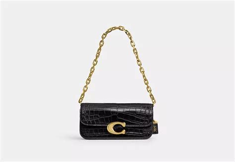 are coach bags expensive|coach's alligator idol purse.